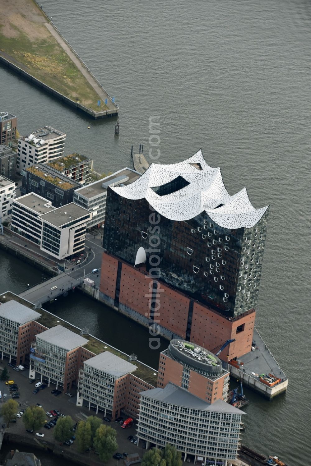 Hamburg from above - The Elbe Philharmonic Hall on the river bank of the Elbe in Hamburg. The building in the district HafenCity is still in process of construction