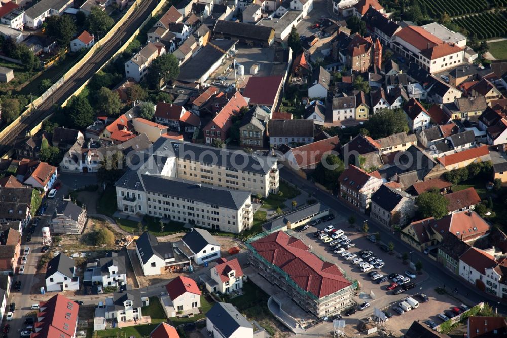 Nierstein from above - Construction site at the location of the former malt factory in the town of Nierstein in the county district of Mainz-Bingen in the state of Rhineland-Palatinate. Originally built as a palace and residence in classicist style, the palace Dalberg - Herding was used as an administrative building an office for the local malt factories. The site is currently refurbished and will be redesigned as a residential compund called Am Schlosspark