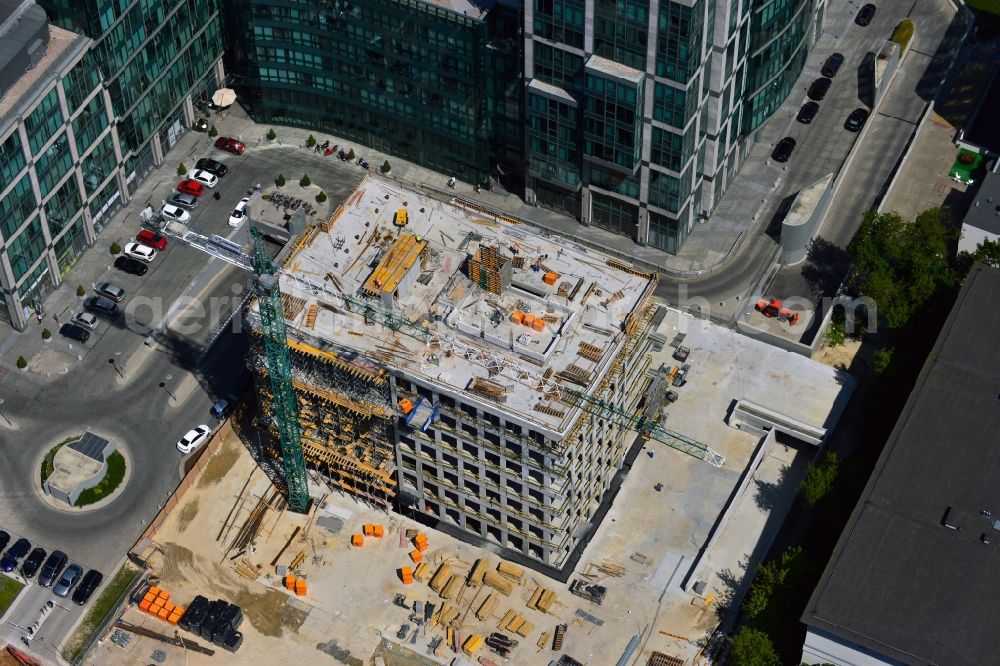 Warschau from above - Construction site behind the office building complex New City in the district of Mokotow in Warsaw in Poland. A new building is created next to a small roundabout. The site used to be a parking lot. The building will be adjacent to New City