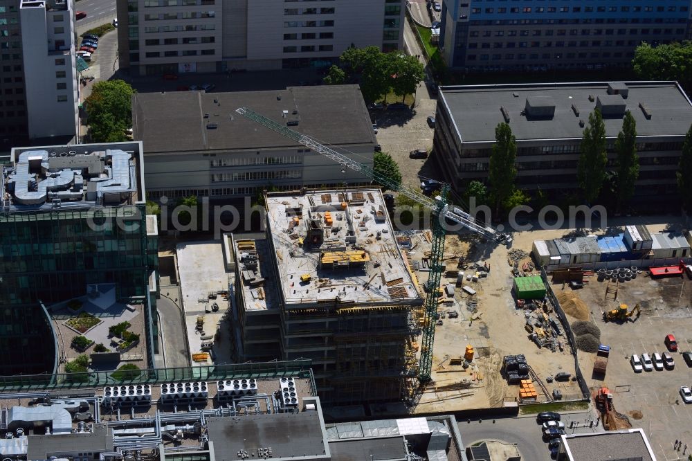 Warschau from above - Construction site behind the office building complex New City in the district of Mokotow in Warsaw in Poland. A new building is created next to a small roundabout. The site used to be a parking lot. The building will be adjacent to New City