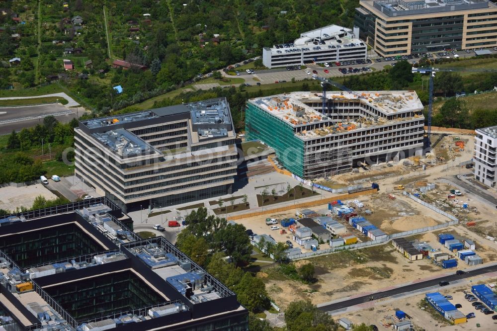 Aerial image Warschau - Construction site behind the Konstruktorska Business Center in the Mokotow District in Warsaw in Poland. The area of the Konstruktorska Street in the West of the district has been developed as a business district with modern office buildings. The Konstruktorska Business Center and the adjacent buildings were built starting in 2012. The buildings in the background are a park deck and the seat of Carlsberg Poland