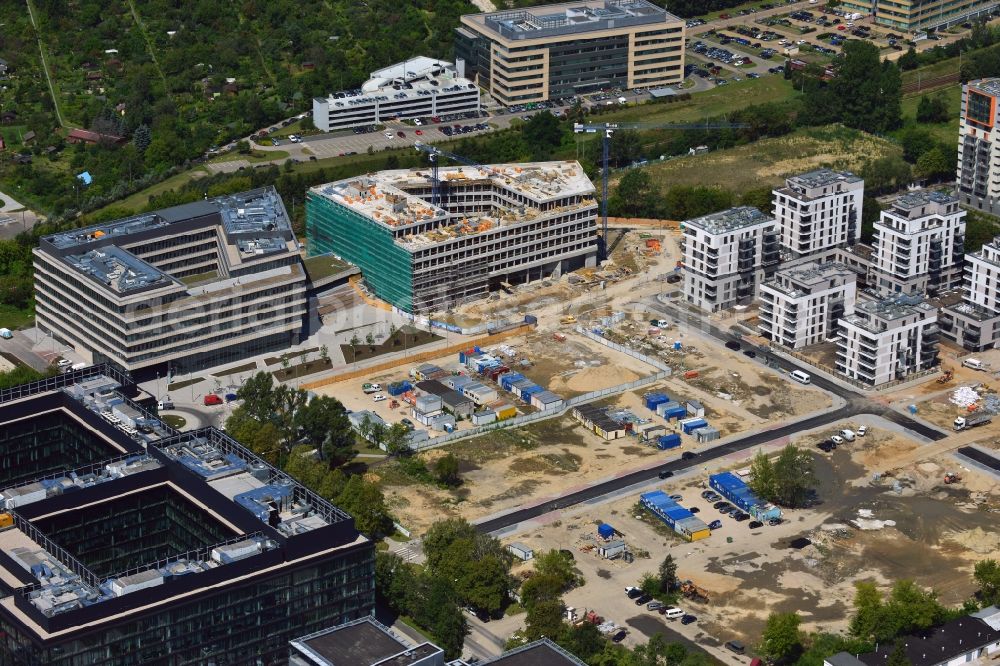 Warschau from above - Construction site behind the Konstruktorska Business Center in the Mokotow District in Warsaw in Poland. The area of the Konstruktorska Street in the West of the district has been developed as a business district with modern office buildings. The Konstruktorska Business Center and the adjacent buildings were built starting in 2012. The buildings in the background are a park deck and the seat of Carlsberg Poland