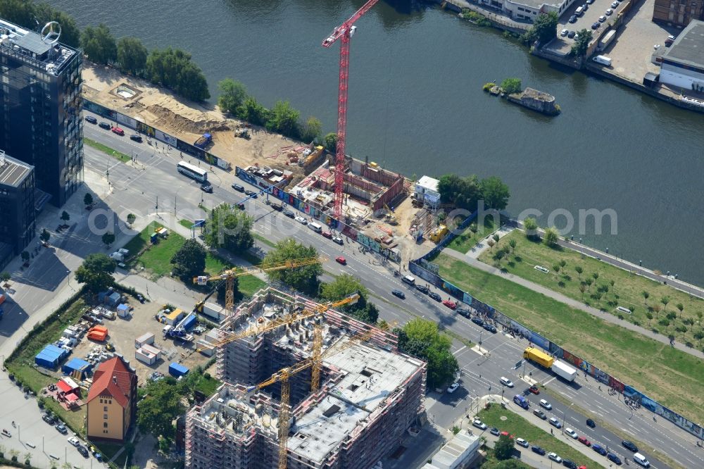 Berlin from above - Construction site of Project Living Levels at Muhlenstrasse on the banks of the River Spree in Berlin - Friedrichshain. On the grounds of the Berlin Wall border strip at the EastSideGallery, the company Living Bauhaus is building a futuristic high-rise residential. The real estate service company City & Home GmbH manages the available apartments