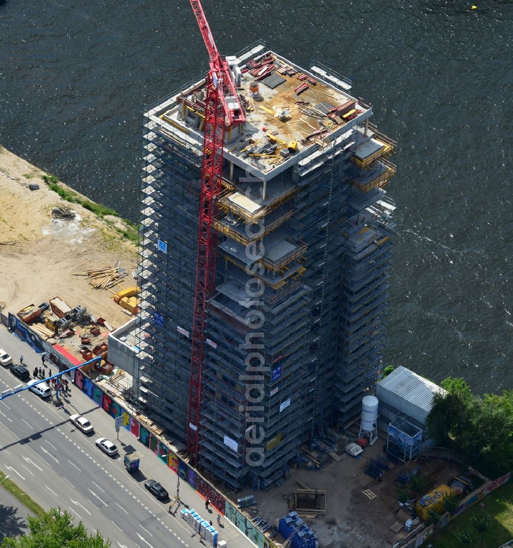 Berlin from above - Construction site of Project Living Levels at Muhlenstrasse on the banks of the River Spree in Berlin - Friedrichshain. On the grounds of the Berlin Wall border strip at the EastSideGallery, the company Living Bauhaus is building a futuristic high-rise residential. The real estate service company City & Home GmbH manages the available apartments