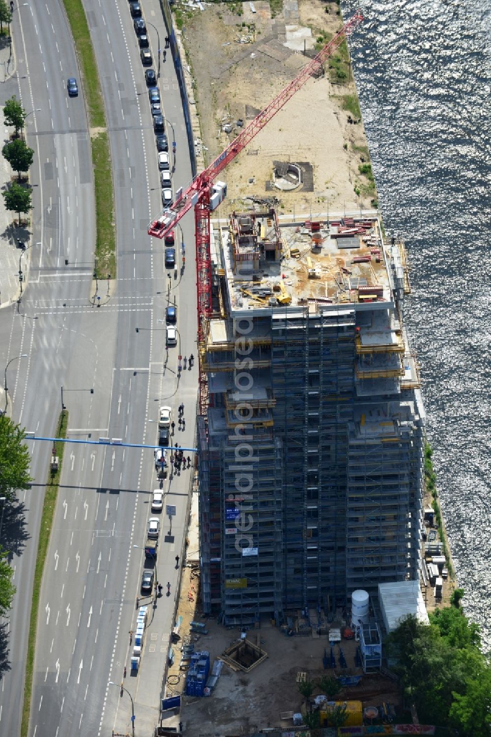 Berlin from above - Construction site of Project Living Levels at Muhlenstrasse on the banks of the River Spree in Berlin - Friedrichshain. On the grounds of the Berlin Wall border strip at the EastSideGallery, the company Living Bauhaus is building a futuristic high-rise residential. The real estate service company City & Home GmbH manages the available apartments