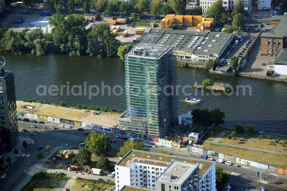 Berlin from above - Construction site of Project Living Levels at Muhlenstrasse on the banks of the River Spree in Berlin - Friedrichshain. On the grounds of the Berlin Wall border strip at the EastSideGallery, the company Living Bauhaus is building a futuristic high-rise residential. The real estate service company City & Home GmbH manages the available apartments