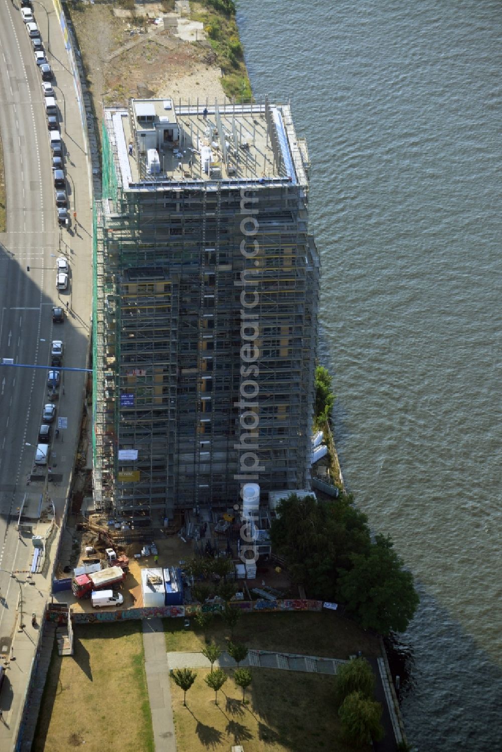 Aerial photograph Berlin - Construction site of Project Living Levels at Muhlenstrasse on the banks of the River Spree in Berlin - Friedrichshain. On the grounds of the Berlin Wall border strip at the EastSideGallery, the company Living Bauhaus is building a futuristic high-rise residential. The real estate service company City & Home GmbH manages the available apartments