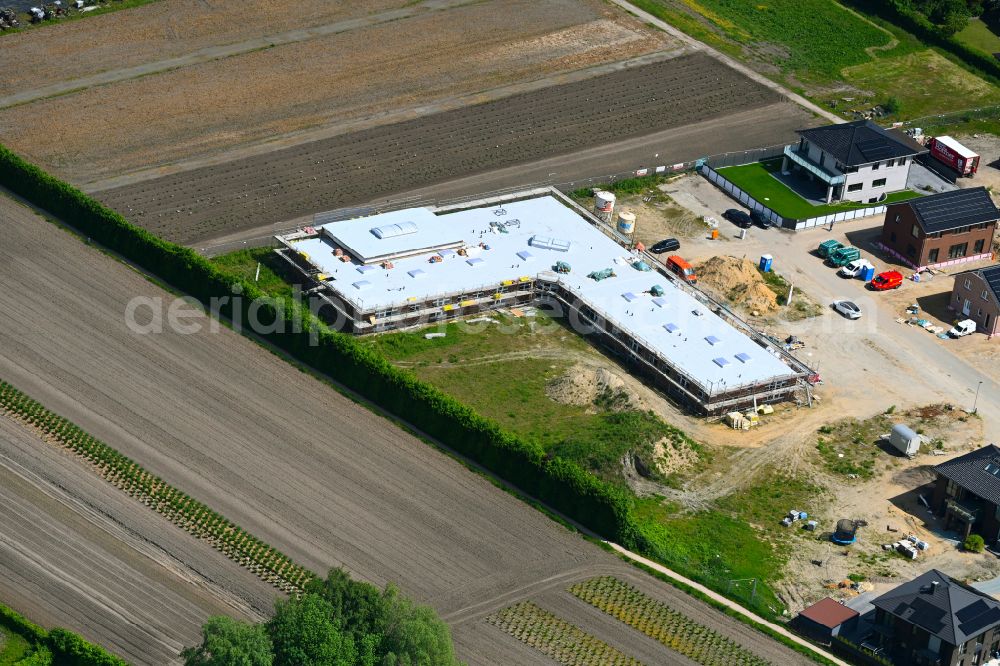 Rellingen from the bird's eye view: New construction site for the construction of a kindergarten building and Nursery school on street Lohacker in Rellingen in the state Schleswig-Holstein, Germany