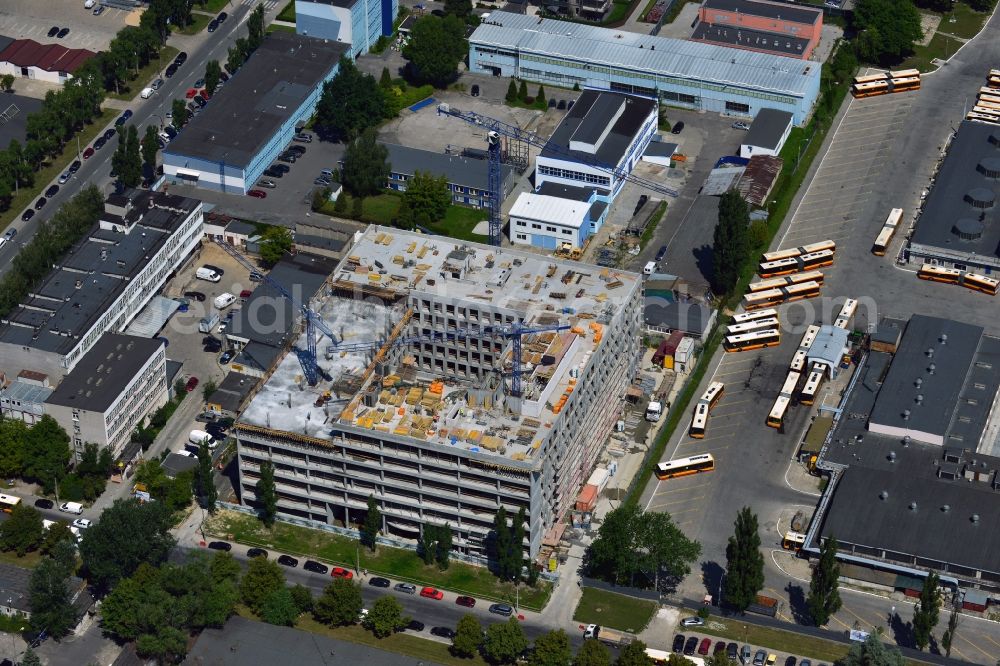 Aerial photograph Warschau - Construction site on Konstruktorska Street in the Mokotow district in Warsaw in Poland. The new development is a project of WB Projekt. It is located adjacent to the bus depot of the district. The square building is currently in the phase of structural work