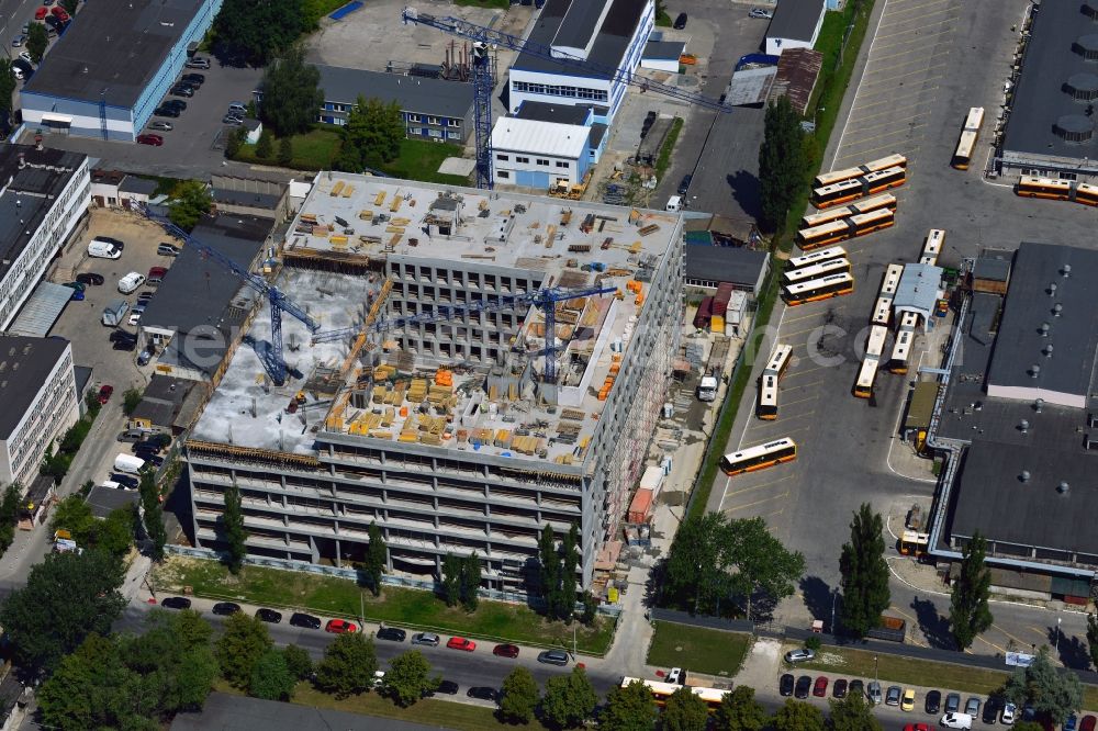 Warschau from the bird's eye view: Construction site on Konstruktorska Street in the Mokotow district in Warsaw in Poland. The new development is a project of WB Projekt. It is located adjacent to the bus depot of the district. The square building is currently in the phase of structural work