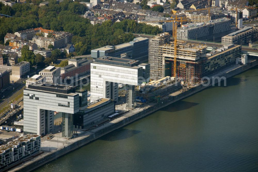 Aerial photograph Köln - Blick auf die Baustelle der Kranhäuser am Kölner Rheinauhafen. Die Bürogebäude sind alle ca. 60 Meter hoch, 34 Meter breit und haben eine Länge von 70 Metern. Entworfen wurden sie vom Architekturbüro BRT Bothe Richter Teherani. Das mittlere Kranhaus wurde als erstes der drei Bürohäuser gebaut und setzte den Anstoß für das nördliche und südliche Kranhaus. Kontakt: BRT Bothe Richter Teherani Architekten, Oberbaumbrücke 1, 20457 Hamburg, Bürohaus Deichtor, Tel. +49(0)40 24842 0, Fax +49(0)40 24842 222, Email: office@brt.de;