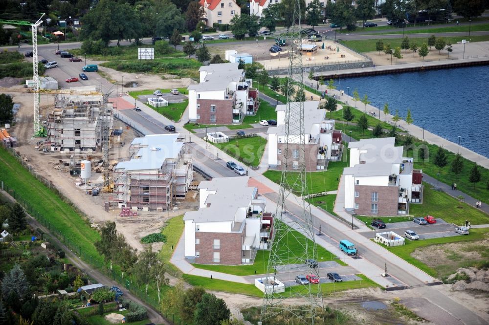 Bitterfeld from the bird's eye view: Construction site of newly built flats at a lake in Bitterfeld in Saxony-Anhalt