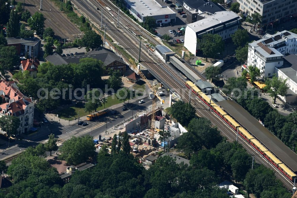 Berlin from above - New construction comany Mark-A. Krueger Bauunternehmung GmbH of the building complex of the shopping center Treskowallee - Am Carlsgarten on city- train station Karlshorst in Berlin