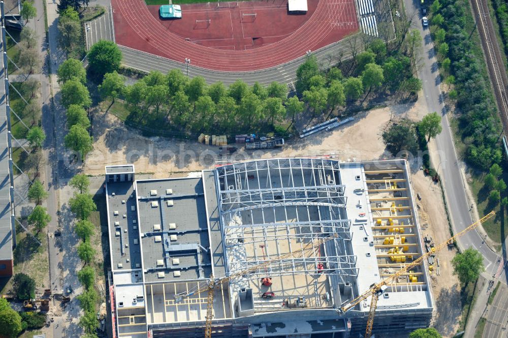 Potsdam from above - Blick auf die Baustelle der Mehrzweck-Sporthalle am Olympia-Stützpunkt Luftschiffhafen im Südwesten Potsdams. Die Landeshauptstadt baut im Rahmen des Konjunkturpaket II mit ihrer stadteigene Unternehmensholding Pro Potsdam die 17 Millionen Euro teuren Mehrzweckhalle. Künftig werden dort maximal 2700 Zuschauer auch internationale Sportwettkämpfe verfolgen können. Im Stützpunkt trainieren unter an deren die Fußballerinnen des FFC Turbine Potsdam sowie die zur Weltspitze zählenden Kanuten des OSC Potsdam. Bislang fehlte in der Stadt eine wettkampftaugliche Halle. Die Bauausführung erfolgt durch die ANES Bauausführungen Berlin GmbH. View the construction site of the multi-purpose sports hall at the Olympic base airship base in the southwest of Potsdam.