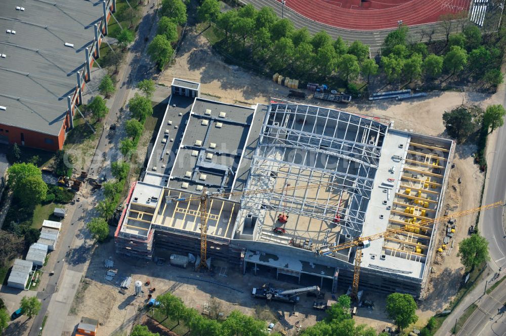 Potsdam from the bird's eye view: Blick auf die Baustelle der Mehrzweck-Sporthalle am Olympia-Stützpunkt Luftschiffhafen im Südwesten Potsdams. Die Landeshauptstadt baut im Rahmen des Konjunkturpaket II mit ihrer stadteigene Unternehmensholding Pro Potsdam die 17 Millionen Euro teuren Mehrzweckhalle. Künftig werden dort maximal 2700 Zuschauer auch internationale Sportwettkämpfe verfolgen können. Im Stützpunkt trainieren unter an deren die Fußballerinnen des FFC Turbine Potsdam sowie die zur Weltspitze zählenden Kanuten des OSC Potsdam. Bislang fehlte in der Stadt eine wettkampftaugliche Halle. Die Bauausführung erfolgt durch die ANES Bauausführungen Berlin GmbH. View the construction site of the multi-purpose sports hall at the Olympic base airship base in the southwest of Potsdam.