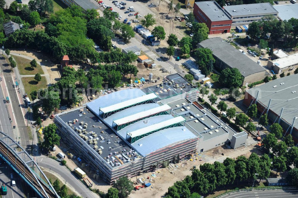 Potsdam from above - Blick auf die Baustelle der Mehrzweck-Sporthalle am Olympia-Stützpunkt Luftschiffhafen im Südwesten Potsdams. Die Landeshauptstadt baut im Rahmen des Konjunkturpaket II mit ihrer stadteigene Unternehmensholding Pro Potsdam die 17 Millionen Euro teuren Mehrzweckhalle. Künftig werden dort maximal 2700 Zuschauer auch internationale Sportwettkämpfe verfolgen können. Im Stützpunkt trainieren unter an deren die Fußballerinnen des FFC Turbine Potsdam sowie die zur Weltspitze zählenden Kanuten des OSC Potsdam. Bislang fehlte in der Stadt eine wettkampftaugliche Halle. Die Bauausführung erfolgt durch die ANES Bauausführungen Berlin GmbH. View the construction site of the multi-purpose sports hall at the Olympic base airship base in the southwest of Potsdam.