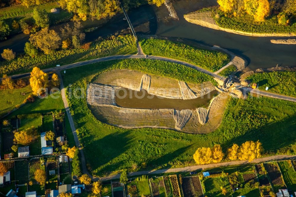 Bamenohl from above - Construction site for the redesign of the course of the river Lenne in the autumnal Bamenohl in the state of North Rhine-Westphalia. The river is being redesigned and will get a small lake on its riverbank, small islands and bicycle lanes