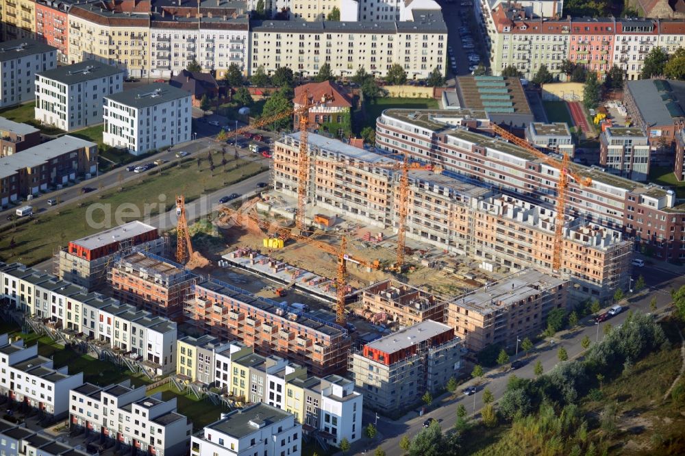 Berlin from the bird's eye view: View at the construction site of a new building and urban house settlement on the site of the former old slaughterhouse in the Thaerstraße in the district Friedrichshain in Berlin. The project was developed by the AVILA Management & Consulting AG in the context of creating a new city quarter. Operating construction company is the MBU Märkische Bau-Union GmbH + Co KG