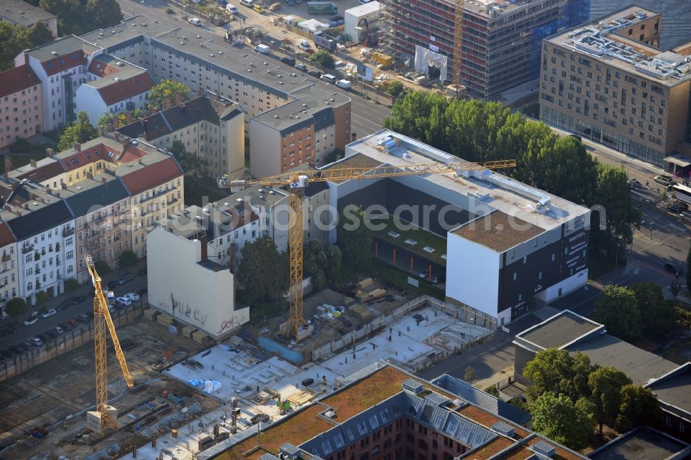 Berlin from above - Look at the construction site of the new building of a residential house with condominiums on the Oberbaum City in the district Friedrichshain in Berlin. It is a project of the AccoNarva Engineering Ltd. The bodyshell has been commissioned by the ANES Construction Work Berlin GmbH