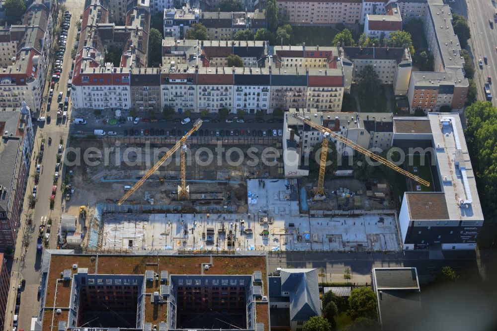 Berlin from the bird's eye view: Look at the construction site of the new building of a residential house with condominiums on the Oberbaum City in the district Friedrichshain in Berlin. It is a project of the AccoNarva Engineering Ltd. The bodyshell has been commissioned by the ANES Construction Work Berlin GmbH