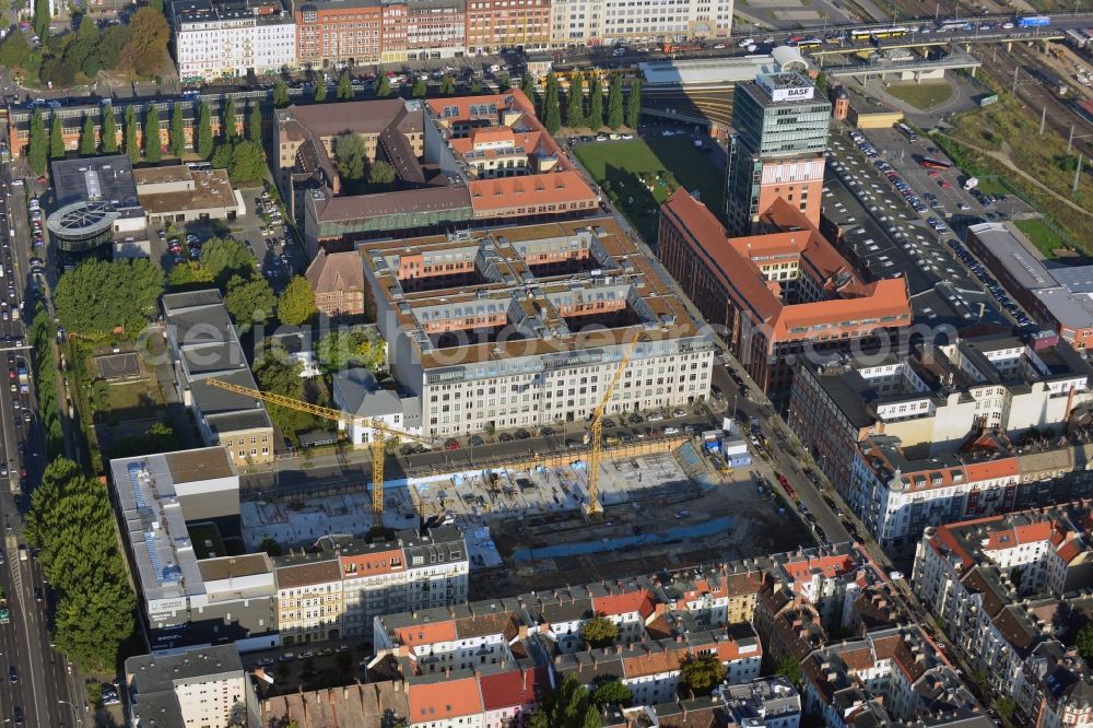 Berlin from the bird's eye view: Look at the construction site of the new building of a residential house with condominiums on the Oberbaum City in the district Friedrichshain in Berlin. It is a project of the AccoNarva Engineering Ltd. The bodyshell has been commissioned by the ANES Construction Work Berlin GmbH