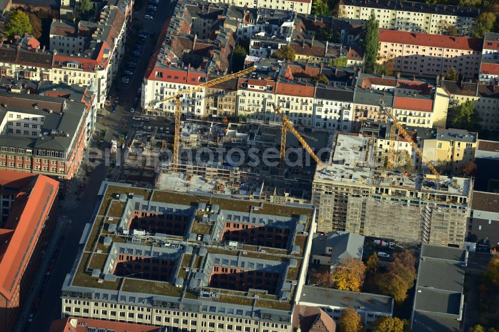 Aerial image Berlin - View the construction site of the new building of a residential house with condominiums on the Oberbaum City in the district Friedrichshain in Berlin. It is a project of the AccoNarva Engineering Ltd. The bodyshell has been commissioned by the ANES Construction Work Berlin GmbH