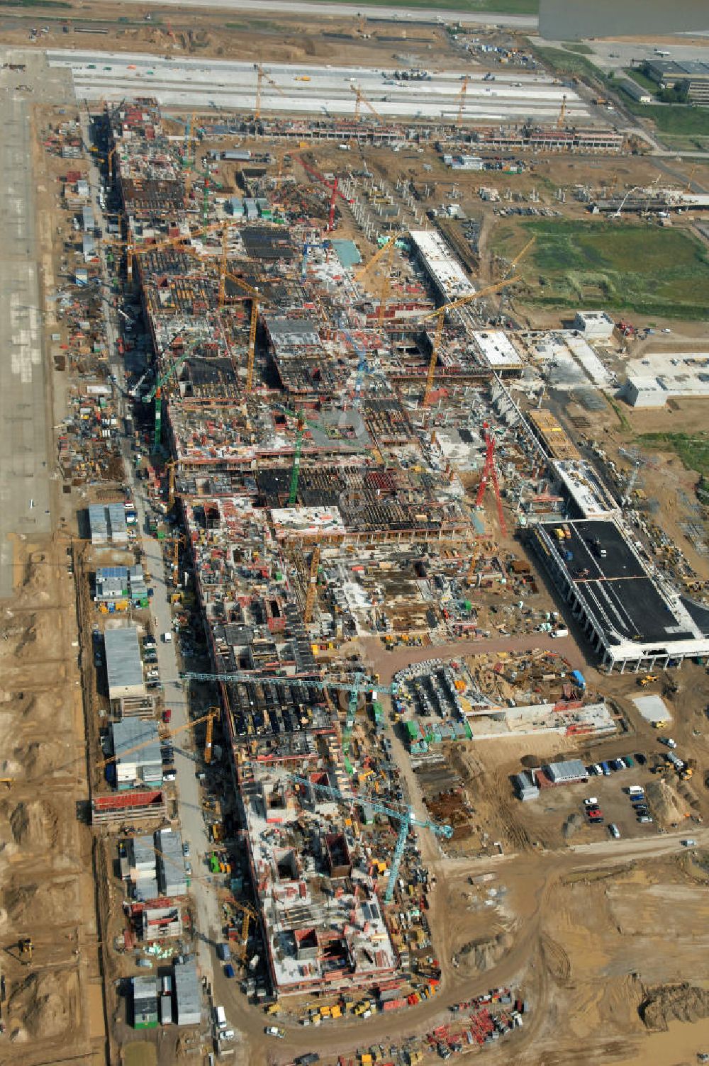 Aerial image Schönefeld - Blick auf die Baustelle des neuen Fern- und S-Bahnhofes der Deutschen Bahn auf der Großbaustelle Neubau Bahnhof BBI (SXF) am Flughafen Berlin - Schönefeld. Ausführende Firmen: Hochtief AG; EUROVIA Beton; PORR; BERGER Bau; Kark Weiss; Matthai; Schäler Bau Berlin GmbH; STRABAG; MAX BÖGL