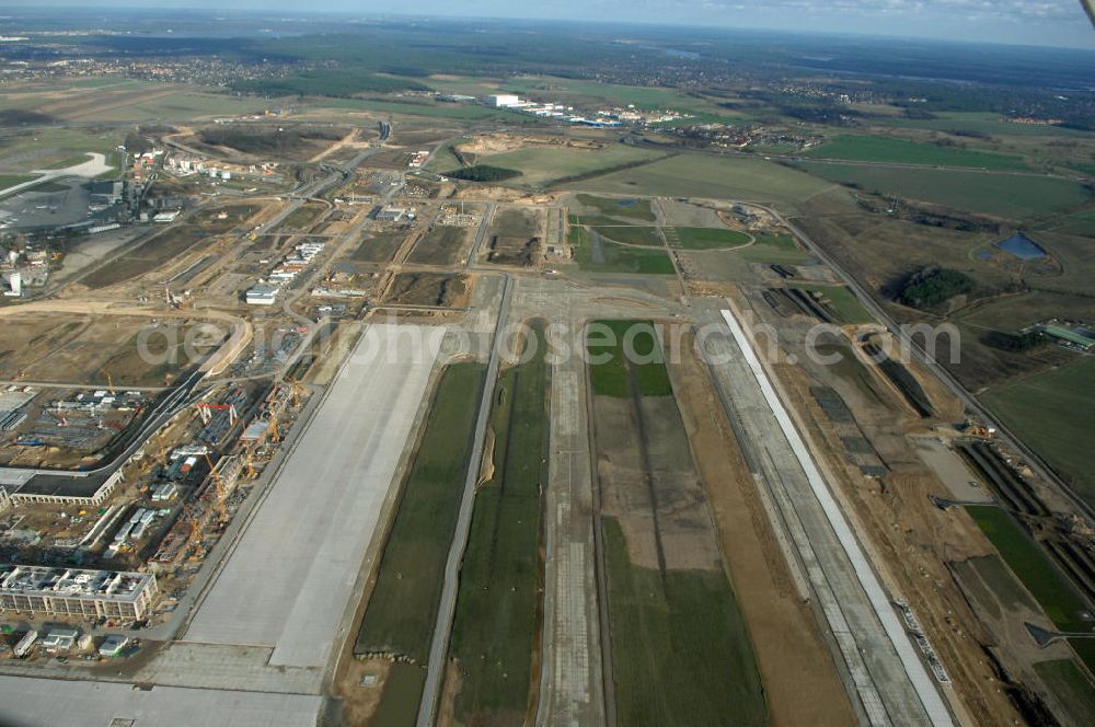 Schönefeld from the bird's eye view: Blick auf die Baustelle der neuen SLB Start- und Landebahn, sowie der angrenzenden Rollwege am Flughafen Berlin-Schönefeld BBI (SXF). Ausführende Firmen: Hochtief AG; EUROVIA Beton; PORR; BERGER Bau; Kark Weiss; Matthai; Schäler Bau Berlin GmbH; STRABAG; MAX BÖGL