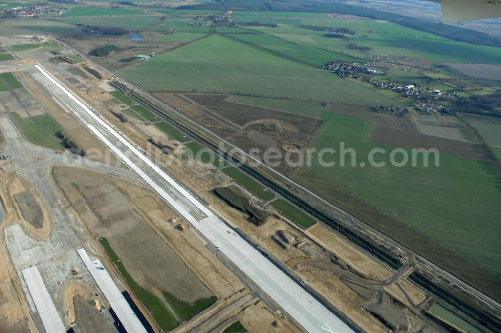 Aerial photograph Schönefeld - Blick auf die Baustelle der neuen SLB Start- und Landebahn, sowie der angrenzenden Rollwege am Flughafen Berlin-Schönefeld BBI (SXF). Ausführende Firmen: Hochtief AG; EUROVIA Beton; PORR; BERGER Bau; Kark Weiss; Matthai; Schäler Bau Berlin GmbH; STRABAG; MAX BÖGL