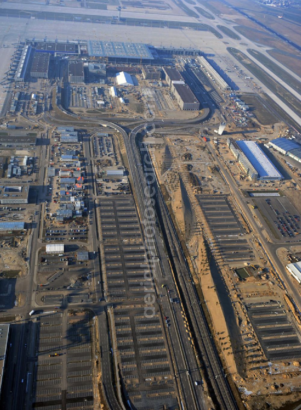 Schönefeld from the bird's eye view: Construction site of the new terminal at Schönefeld Airport ( BBI or BER , sobriquet: Willy Brandt ). The new terminal will be built in the south of the airport Berlin - Schönefeld. Executing companies: Hochtief AG; EUROVIA Beton; PORR; BERGER Bau; Karl Weiss; Matthai; Schäler Bau Berlin GmbH; STRABAG