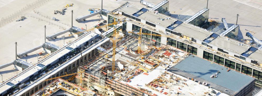 Aerial photograph Berlin Schönefeld - Baustelle des neuen Terminals am Flughafen Schönefeld (BBI). Der neue Terminal wird südlich des jetzigen Flughafens Berlin- Schönefeld errichtet. Ausführende Firmen: Hochtief AG; EUROVIA Beton; PORR; BERGER Bau; Karl Weiss; Matthai; Schäler Bau Berlin GmbH; STRABAG; Construction area of the new terminal at Schönefeld Airport (BBI). The new terminal is in the south of the airport Berlin -Schoenefeld quality built. Exporting companies: Hochtief AG; EUROVIA Beton; PORR; BERGER Bau; Karl Weiss; Matthai; Schäler Bau Berlin GmbH; STRABAG;