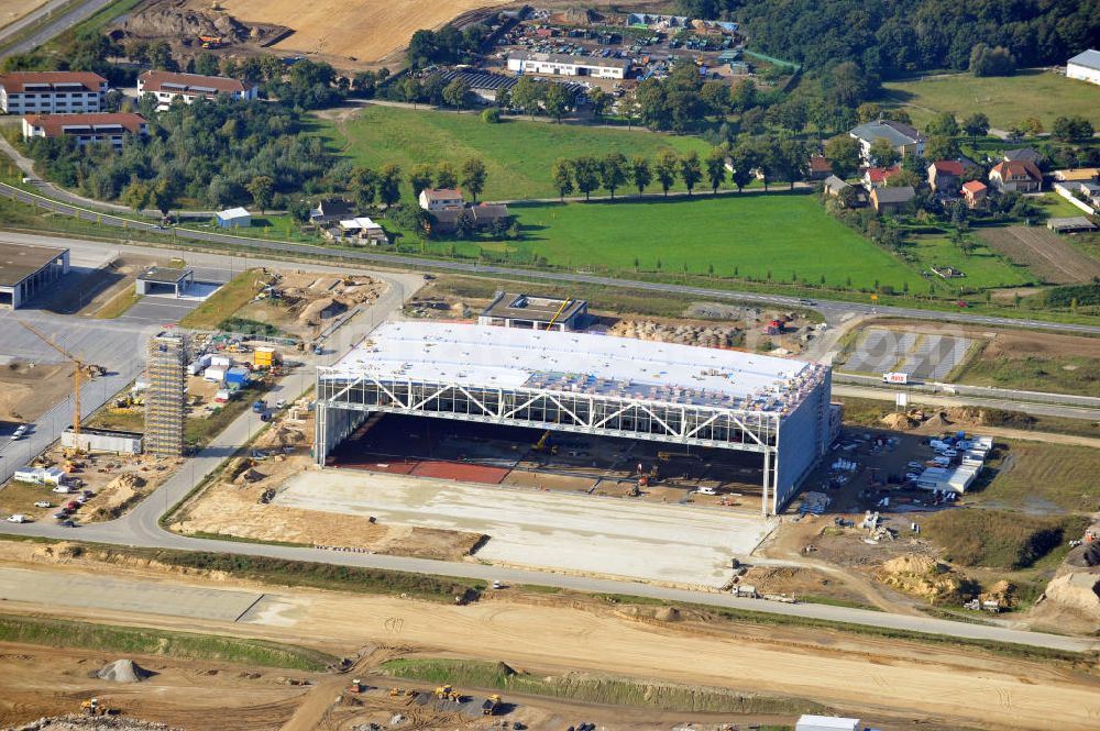 Aerial photograph Berlin Schönefeld - Baustelle des neuen Terminals am Flughafen Schönefeld (BBI). Der neue Terminal wird südlich des jetzigen Flughafens Berlin- Schönefeld errichtet. Ausführende Firmen: Hochtief AG; EUROVIA Beton; PORR; BERGER Bau; Karl Weiss; Matthai; Schäler Bau Berlin GmbH; STRABAG; Construction area of the new terminal at Schönefeld Airport (BBI). The new terminal is in the south of the airport Berlin -Schoenefeld quality built. Exporting companies: Hochtief AG; EUROVIA Beton; PORR; BERGER Bau; Karl Weiss; Matthai; Schäler Bau Berlin GmbH; STRABAG;