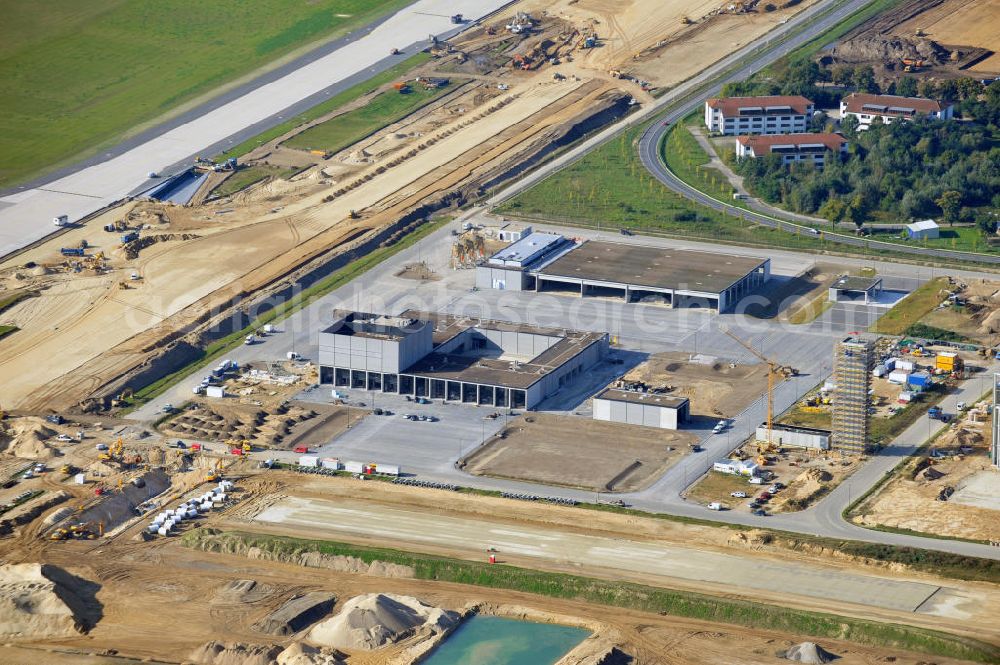 Berlin Schönefeld from above - Baustelle des neuen Terminals am Flughafen Schönefeld (BBI). Der neue Terminal wird südlich des jetzigen Flughafens Berlin- Schönefeld errichtet. Ausführende Firmen: Hochtief AG; EUROVIA Beton; PORR; BERGER Bau; Karl Weiss; Matthai; Schäler Bau Berlin GmbH; STRABAG; Construction area of the new terminal at Schönefeld Airport (BBI). The new terminal is in the south of the airport Berlin -Schoenefeld quality built. Exporting companies: Hochtief AG; EUROVIA Beton; PORR; BERGER Bau; Karl Weiss; Matthai; Schäler Bau Berlin GmbH; STRABAG;