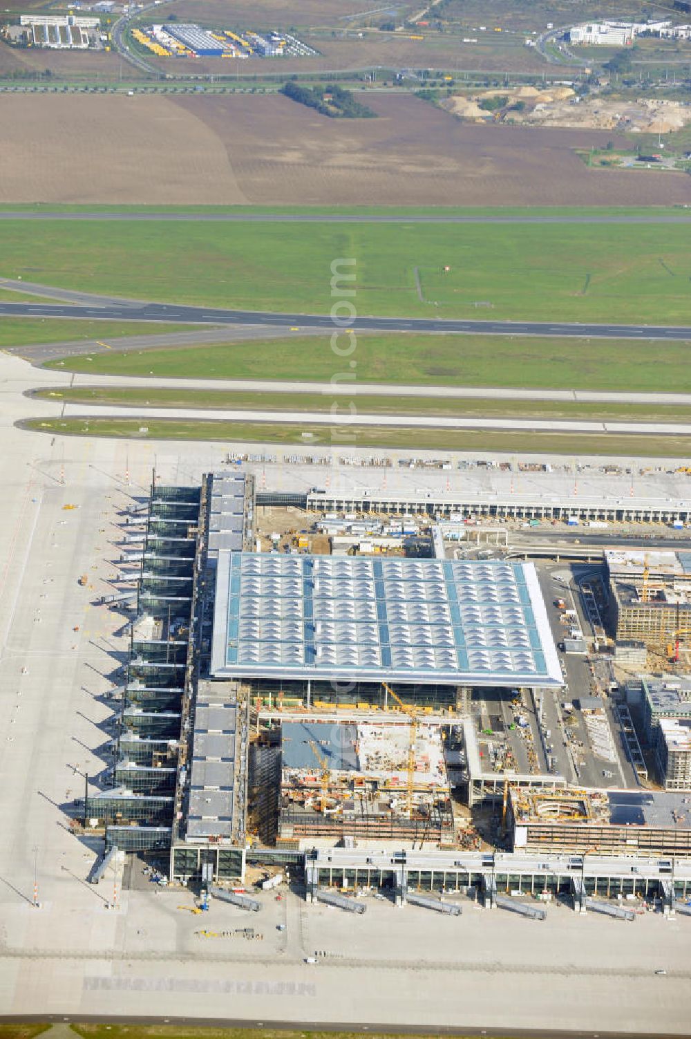 Berlin Schönefeld from above - Baustelle des neuen Terminals am Flughafen Schönefeld (BBI). Der neue Terminal wird südlich des jetzigen Flughafens Berlin- Schönefeld errichtet. Ausführende Firmen: Hochtief AG; EUROVIA Beton; PORR; BERGER Bau; Karl Weiss; Matthai; Schäler Bau Berlin GmbH; STRABAG; Construction area of the new terminal at Schönefeld Airport (BBI). The new terminal is in the south of the airport Berlin -Schoenefeld quality built. Exporting companies: Hochtief AG; EUROVIA Beton; PORR; BERGER Bau; Karl Weiss; Matthai; Schäler Bau Berlin GmbH; STRABAG;