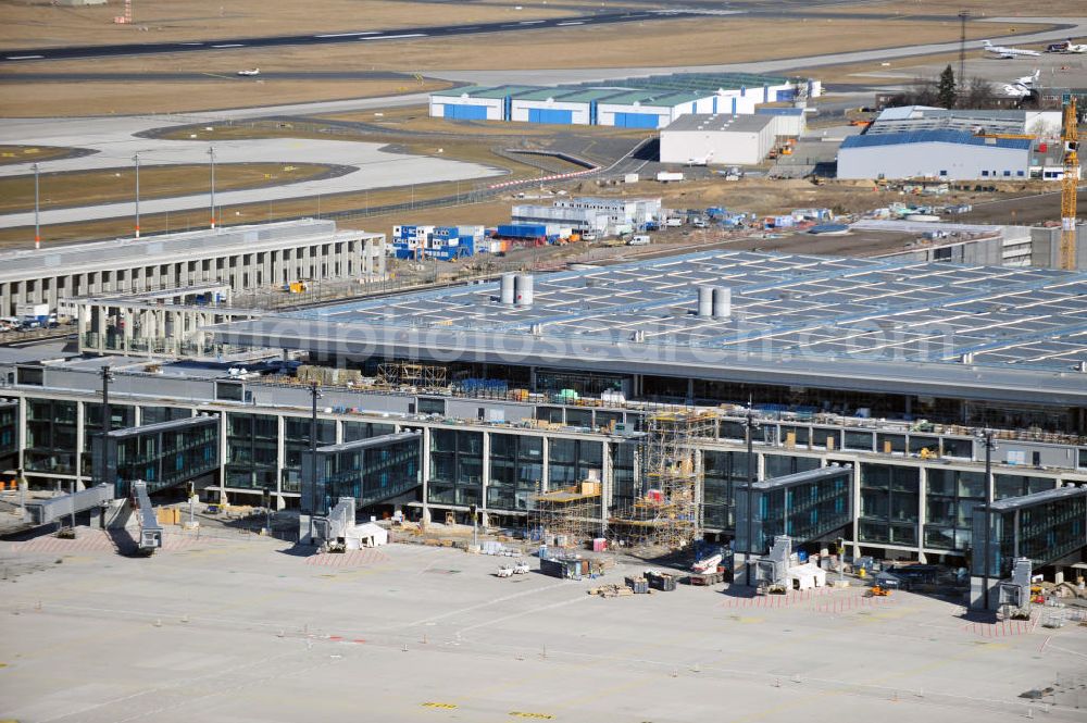 Schönefeld from the bird's eye view: Construction area of the new terminal at Schönefeld Airport (BBI). The new terminal is in the south of the airport Berlin -Schoenefeld quality built. Exporting companies: Hochtief AG; EUROVIA Beton; PORR; BERGER Bau; Karl Weiss; Matthai; Schäler Bau Berlin GmbH; STRABAG;