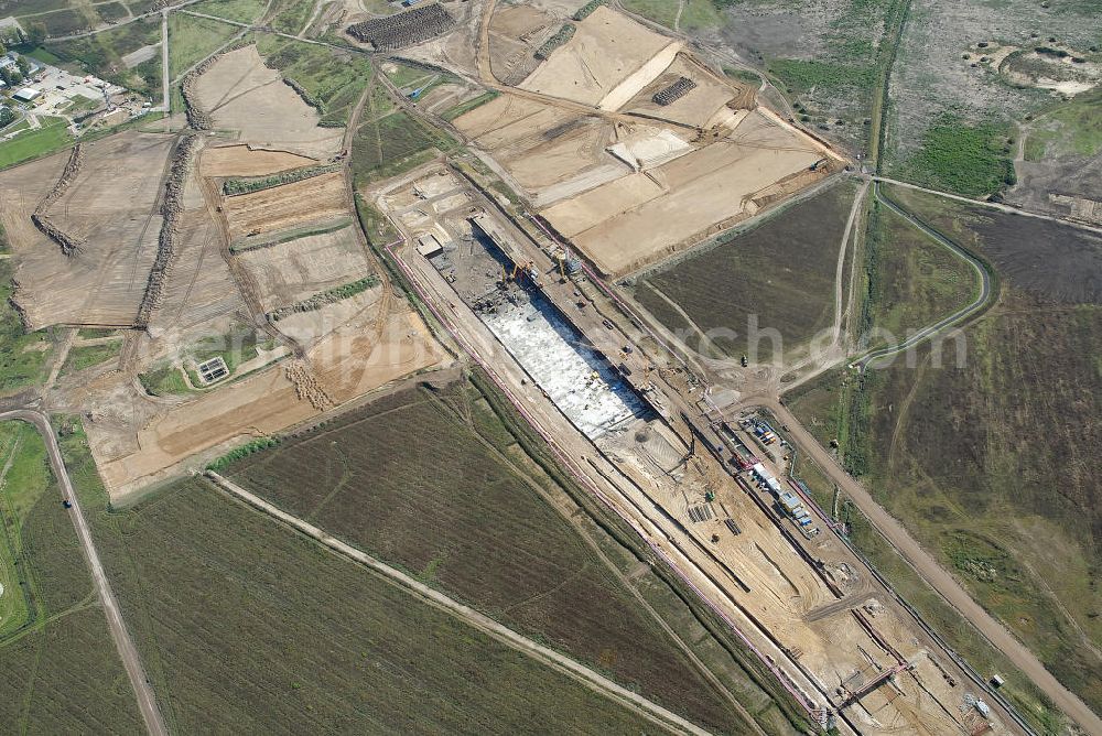 Aerial image Schönefeld - Baustelle des neuen Terminals am Flughafen Schönefeld (BBI). Der neue Terminal wird südlich des jetzigen Flughafens Berlin- Schönefeld errichtet. Ausführende Firmen: Hochtief AG; EUROVIA Beton; PORR; BERGER Bau; Karl Weiss; Matthai; Schäler Bau Berlin GmbH; STRABAG; MAX BÖGL. Construction area of the new terminal at Schönefeld Airport (BBI). The new terminal is in the south of the airport Berlin-Schoenefeld quality built. Exporting companies: Hochtief AG; EUROVIA Beton; PORR; BERGER Bau; Karl Weiss; Matthai; Schäler Bau Berlin GmbH; STRABAG; MAX BÖGL.