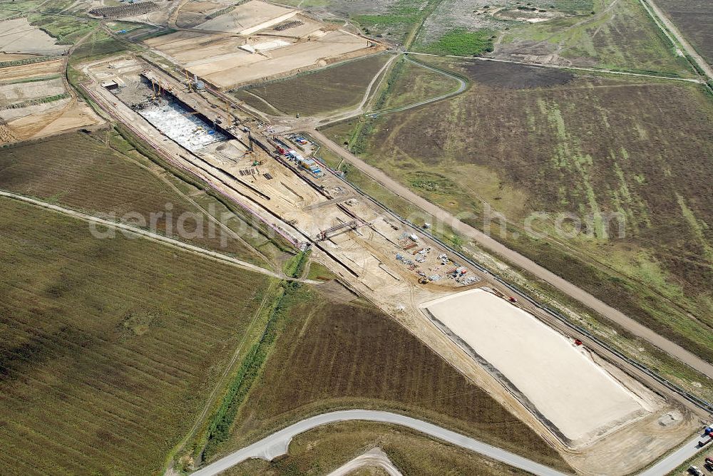 Aerial photograph Schönefeld - Baustelle des neuen Terminals am Flughafen Schönefeld (BBI). Der neue Terminal wird südlich des jetzigen Flughafens Berlin- Schönefeld errichtet. Ausführende Firmen: Hochtief AG; EUROVIA Beton; PORR; BERGER Bau; Karl Weiss; Matthai; Schäler Bau Berlin GmbH; STRABAG; MAX BÖGL. Construction area of the new terminal at Schönefeld Airport (BBI). The new terminal is in the south of the airport Berlin-Schoenefeld quality built. Exporting companies: Hochtief AG; EUROVIA Beton; PORR; BERGER Bau; Karl Weiss; Matthai; Schäler Bau Berlin GmbH; STRABAG; MAX BÖGL.