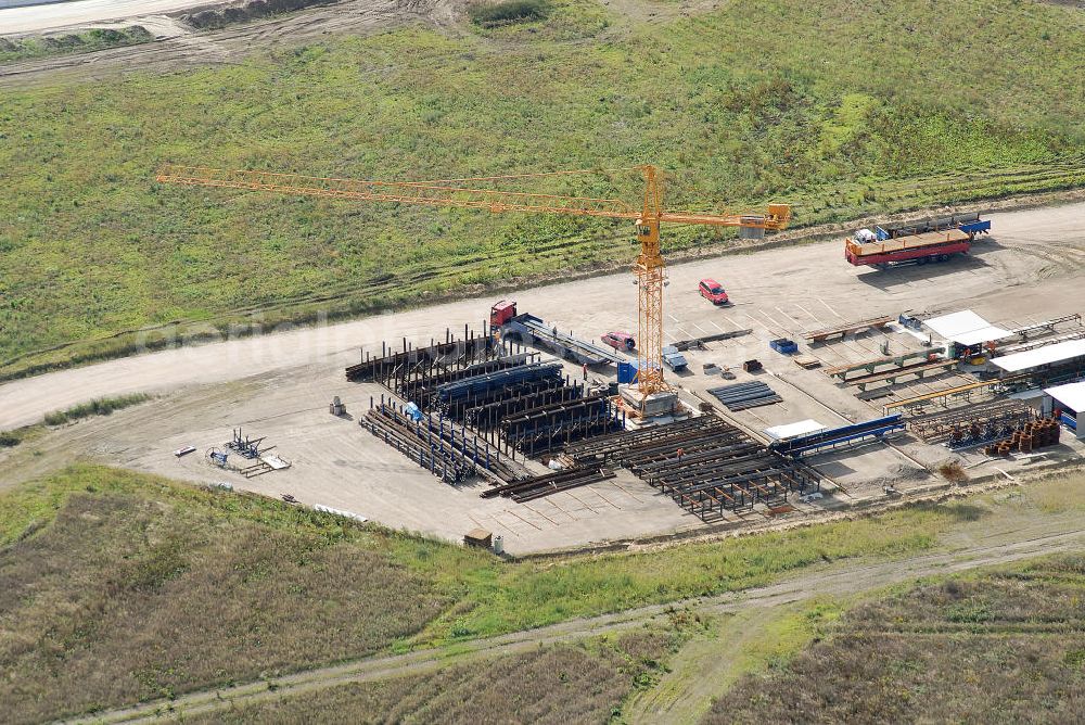 Schönefeld from the bird's eye view: Baustelle des neuen Terminals am Flughafen Schönefeld (BBI). Der neue Terminal wird südlich des jetzigen Flughafens Berlin- Schönefeld errichtet. Ausführende Firmen: Hochtief AG; EUROVIA Beton; PORR; BERGER Bau; Karl Weiss; Matthai; Schäler Bau Berlin GmbH; STRABAG; MAX BÖGL. Construction area of the new terminal at Schönefeld Airport (BBI). The new terminal is in the south of the airport Berlin-Schoenefeld quality built. Exporting companies: Hochtief AG; EUROVIA Beton; PORR; BERGER Bau; Karl Weiss; Matthai; Schäler Bau Berlin GmbH; STRABAG; MAX BÖGL.