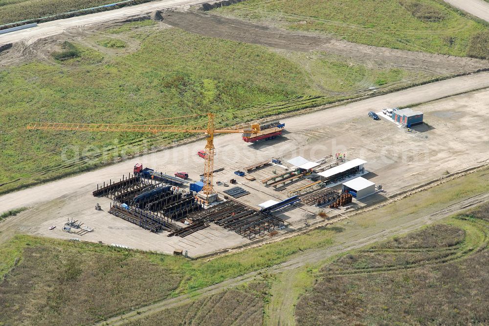 Aerial photograph Schönefeld - Baustelle des neuen Terminals am Flughafen Schönefeld (BBI). Der neue Terminal wird südlich des jetzigen Flughafens Berlin- Schönefeld errichtet. Ausführende Firmen: Hochtief AG; EUROVIA Beton; PORR; BERGER Bau; Karl Weiss; Matthai; Schäler Bau Berlin GmbH; STRABAG; MAX BÖGL. Construction area of the new terminal at Schönefeld Airport (BBI). The new terminal is in the south of the airport Berlin-Schoenefeld quality built. Exporting companies: Hochtief AG; EUROVIA Beton; PORR; BERGER Bau; Karl Weiss; Matthai; Schäler Bau Berlin GmbH; STRABAG; MAX BÖGL.