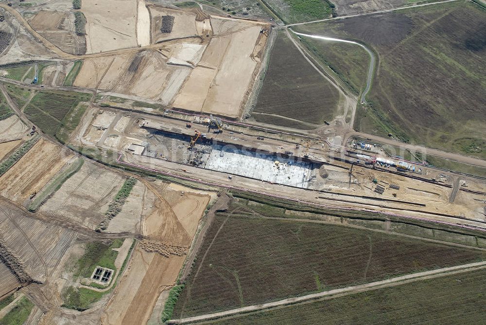 Aerial photograph Schönefeld - Baustelle des neuen Terminals am Flughafen Schönefeld (BBI). Der neue Terminal wird südlich des jetzigen Flughafens Berlin- Schönefeld errichtet. Ausführende Firmen: Hochtief AG; EUROVIA Beton; PORR; BERGER Bau; Karl Weiss; Matthai; Schäler Bau Berlin GmbH; STRABAG; MAX BÖGL. Construction area of the new terminal at Schönefeld Airport (BBI). The new terminal is in the south of the airport Berlin-Schoenefeld quality built. Exporting companies: Hochtief AG; EUROVIA Beton; PORR; BERGER Bau; Karl Weiss; Matthai; Schäler Bau Berlin GmbH; STRABAG; MAX BÖGL.