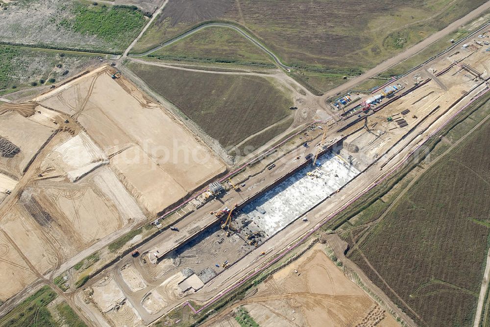 Schönefeld from the bird's eye view: Baustelle des neuen Terminals am Flughafen Schönefeld (BBI). Der neue Terminal wird südlich des jetzigen Flughafens Berlin- Schönefeld errichtet. Ausführende Firmen: Hochtief AG; EUROVIA Beton; PORR; BERGER Bau; Karl Weiss; Matthai; Schäler Bau Berlin GmbH; STRABAG; MAX BÖGL. Construction area of the new terminal at Schönefeld Airport (BBI). The new terminal is in the south of the airport Berlin-Schoenefeld quality built. Exporting companies: Hochtief AG; EUROVIA Beton; PORR; BERGER Bau; Karl Weiss; Matthai; Schäler Bau Berlin GmbH; STRABAG; MAX BÖGL.