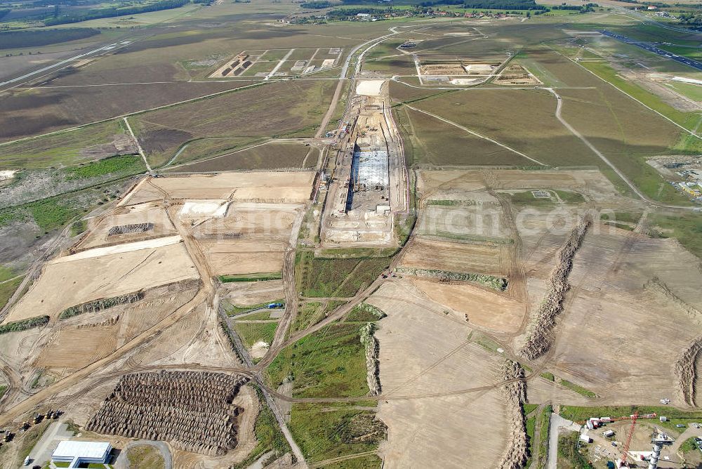 Schönefeld from the bird's eye view: Baustelle des neuen Terminals am Flughafen Schönefeld (BBI). Der neue Terminal wird südlich des jetzigen Flughafens Berlin- Schönefeld errichtet. Ausführende Firmen: Hochtief AG; EUROVIA Beton; PORR; BERGER Bau; Karl Weiss; Matthai; Schäler Bau Berlin GmbH; STRABAG; MAX BÖGL. Construction area of the new terminal at Schönefeld Airport (BBI). The new terminal is in the south of the airport Berlin-Schoenefeld quality built. Exporting companies: Hochtief AG; EUROVIA Beton; PORR; BERGER Bau; Karl Weiss; Matthai; Schäler Bau Berlin GmbH; STRABAG; MAX BÖGL.