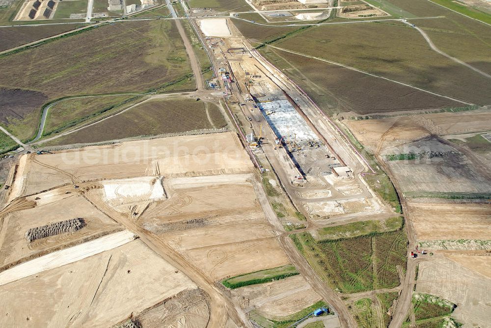 Schönefeld from above - Baustelle des neuen Terminals am Flughafen Schönefeld (BBI). Der neue Terminal wird südlich des jetzigen Flughafens Berlin- Schönefeld errichtet. Ausführende Firmen: Hochtief AG; EUROVIA Beton; PORR; BERGER Bau; Karl Weiss; Matthai; Schäler Bau Berlin GmbH; STRABAG; MAX BÖGL. Construction area of the new terminal at Schönefeld Airport (BBI). The new terminal is in the south of the airport Berlin-Schoenefeld quality built. Exporting companies: Hochtief AG; EUROVIA Beton; PORR; BERGER Bau; Karl Weiss; Matthai; Schäler Bau Berlin GmbH; STRABAG; MAX BÖGL.