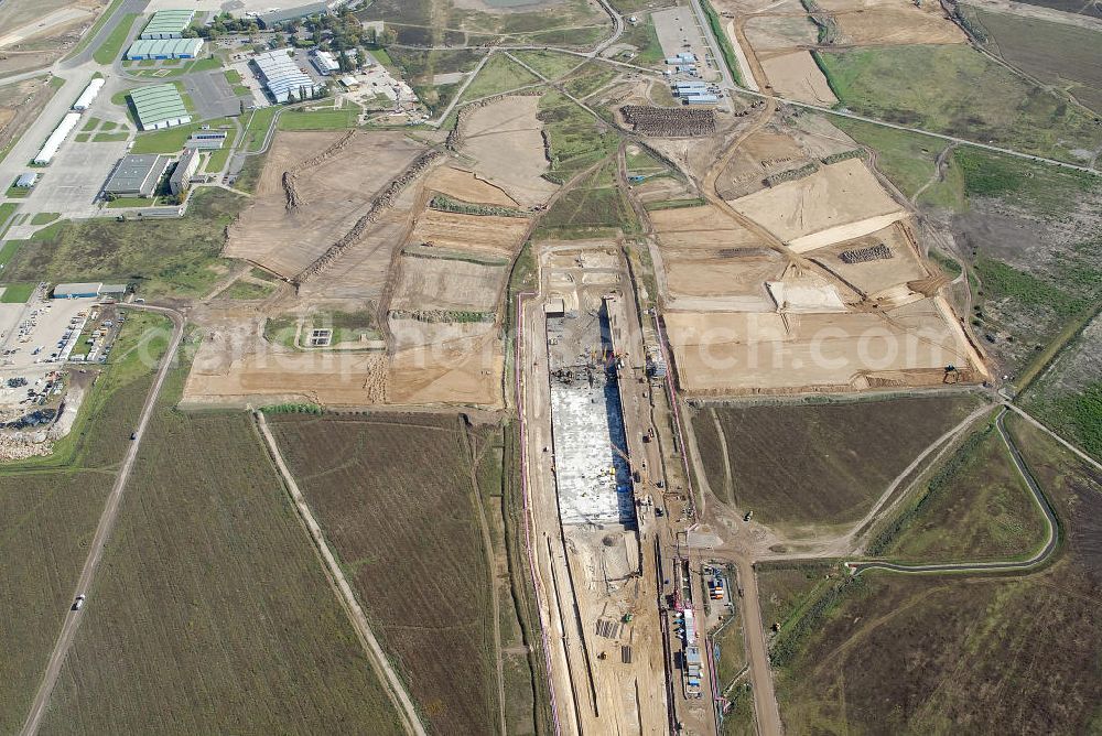 Schönefeld from above - Baustelle des neuen Terminals am Flughafen Schönefeld (BBI). Der neue Terminal wird südlich des jetzigen Flughafens Berlin- Schönefeld errichtet. Ausführende Firmen: Hochtief AG; EUROVIA Beton; PORR; BERGER Bau; Karl Weiss; Matthai; Schäler Bau Berlin GmbH; STRABAG; MAX BÖGL. Construction area of the new terminal at Schönefeld Airport (BBI). The new terminal is in the south of the airport Berlin-Schoenefeld quality built. Exporting companies: Hochtief AG; EUROVIA Beton; PORR; BERGER Bau; Karl Weiss; Matthai; Schäler Bau Berlin GmbH; STRABAG; MAX BÖGL.