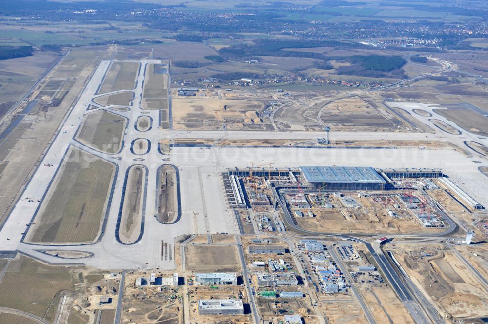 Aerial photograph Schönefeld - Baustelle des neuen Terminals am Flughafen Schönefeld (BBI). Der neue Terminal wird südlich des jetzigen Flughafens Berlin- Schönefeld errichtet. Ausführende Firmen: Hochtief AG; EUROVIA Beton; PORR; BERGER Bau; Karl Weiss; Matthai; Schäler Bau Berlin GmbH; STRABAG; Construction area of the new terminal at Schönefeld Airport (BBI). The new terminal is in the south of the airport Berlin-Schoenefeld quality built. Exporting companies: Hochtief AG; EUROVIA Beton; PORR; BERGER Bau; Karl Weiss; Matthai; Schäler Bau Berlin GmbH; STRABAG;