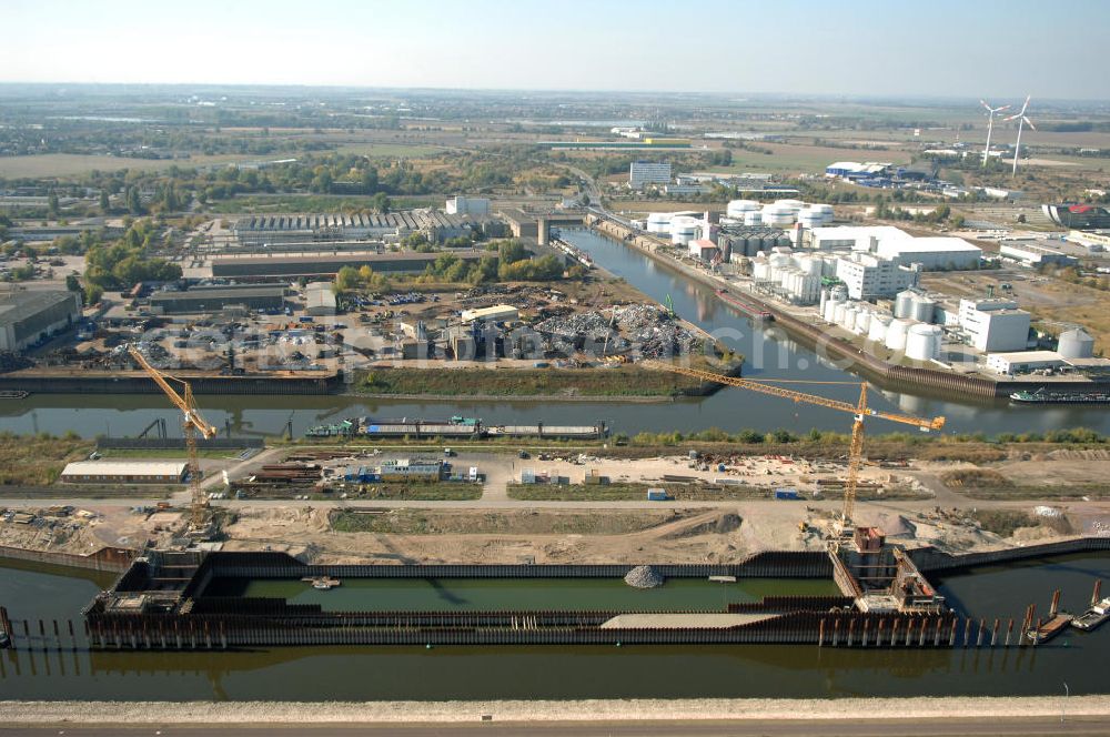 Magdeburg from the bird's eye view: Blick auf die Baustelle der Niedrigwasserschleuse an der Steinkopfinsel im Hafen Magdeburg an der Elbe. Umflossen wird die Steinkopfinsel im Osten von der Elbe und dem Abstiegskanal Rothensee, sowie im Westen vom Zweigkanal Magdeburg. Die Insel ist ca. 2,5 km lang und ca. 0,3 km breit (an der stärksten Stelle). Der Binnenhafen ist in vier Güterumschlagplätze eingeteilt, der Handelshafen, Industriehafen, Kanalhafen und der Hanseshafen. Das Gebiet verteilt sich über die Stadtteile Alte-Neustadt, Industriehafen und Gewerbegebiet Nord. Jedoch hat der Handelshafen für die Schiffahrt heute keine Bedeutung mehr, dieser Bereich wird stetig zum Wissenschaftsstandort umgebaut. Kontakt: Magdeburger Hafen GmbH, Saalestraße 20, 39126 Magdeburg, Tel. +49(0)391 5939-0, Fax +49(0)391 5616648, email: Logistik@magdeburg-hafen.de; Kontakt WSV: Wasserstraßen-Neubauamt Magdeburg, 39106 Magdeburg, Tel. +49(0)391 535-0, email: wna-magdeburg@wsv.bund.de