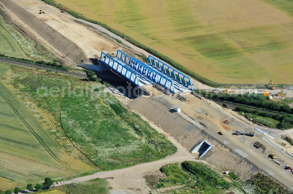 Bernburg from the bird's eye view: Baustelle vom Neubau der Ortsumgehung Bernburg Bundesstraße B 6n mit Anschlußstelle an die Autobahn / Bundesautobahn A 14 in Sachsen-Anhalt. Ein Projekt von EUROVIA. Construction site of the new circuitous road B6n Bernburg with the new junction on to the freeway in the near of Bernburg in Saxony-Anhalt.