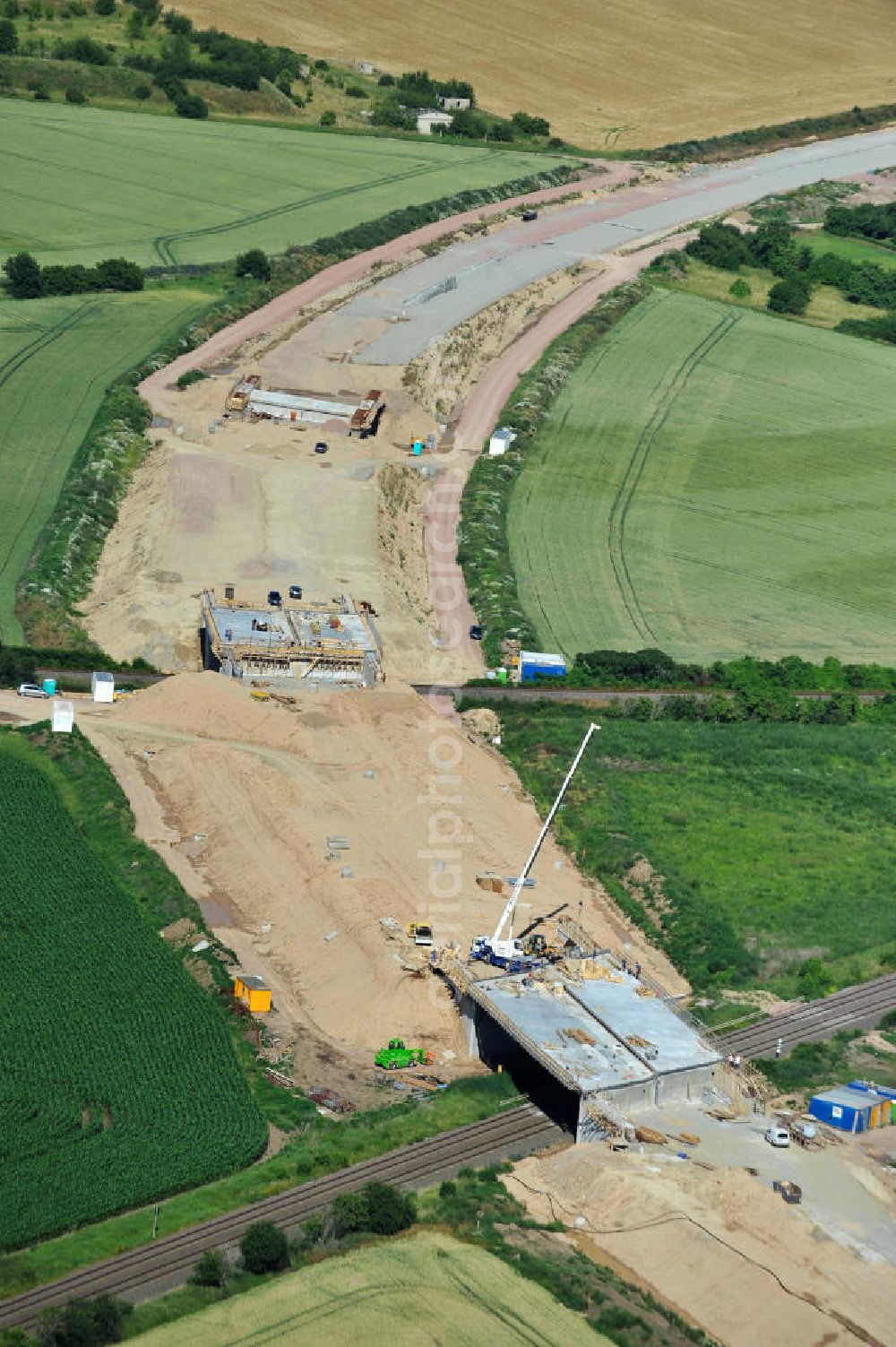 Bernburg from the bird's eye view: Baustelle vom Neubau der Ortsumgehung Bernburg Bundesstraße B 6n mit Anschlußstelle an die Autobahn / Bundesautobahn A 14 in Sachsen-Anhalt. Ein Projekt von EUROVIA. Construction site of the new circuitous road B6n Bernburg with the new junction on to the freeway in the near of Bernburg in Saxony-Anhalt.