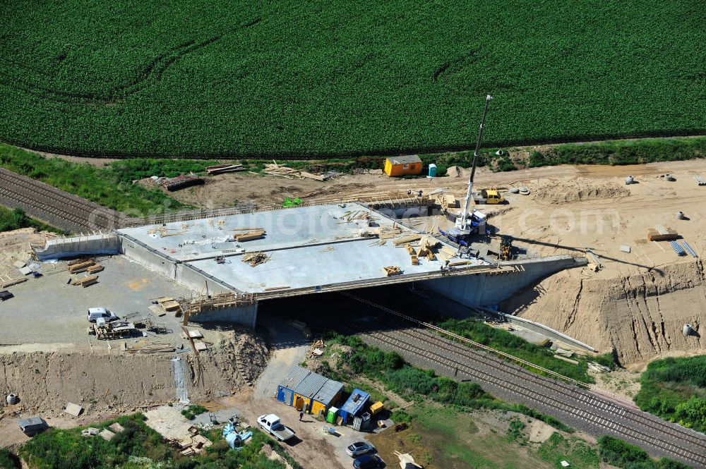 Bernburg from the bird's eye view: Baustelle vom Neubau der Ortsumgehung Bernburg Bundesstraße B 6n mit Anschlußstelle an die Autobahn / Bundesautobahn A 14 in Sachsen-Anhalt. Ein Projekt von EUROVIA. Construction site of the new circuitous road B6n Bernburg with the new junction on to the freeway in the near of Bernburg in Saxony-Anhalt.