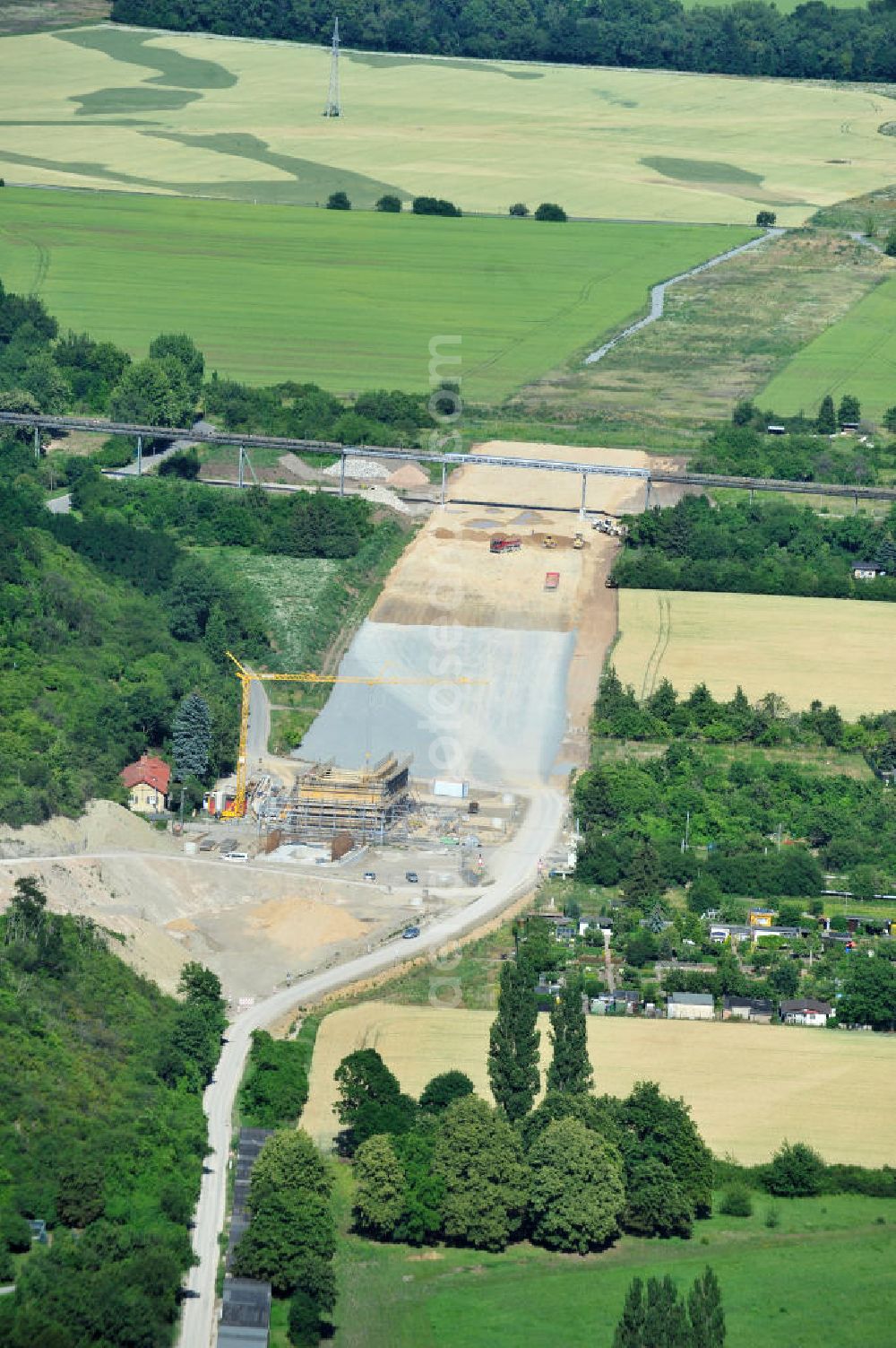 Aerial image Bernburg - Baustelle vom Neubau der Ortsumgehung Bernburg Bundesstraße B 6n mit Anschlußstelle an die Autobahn / Bundesautobahn A 14 in Sachsen-Anhalt. Ein Projekt von EUROVIA. Construction site of the new circuitous road B6n Bernburg with the new junction on to the freeway in the near of Bernburg in Saxony-Anhalt.